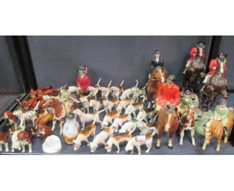 A collection of Beswick hunting figures, comprising horses and riders, foxes and hounds  