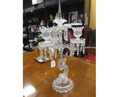 A three light candelabrum supported by a frosted glass dolphin, 60 cm high  
