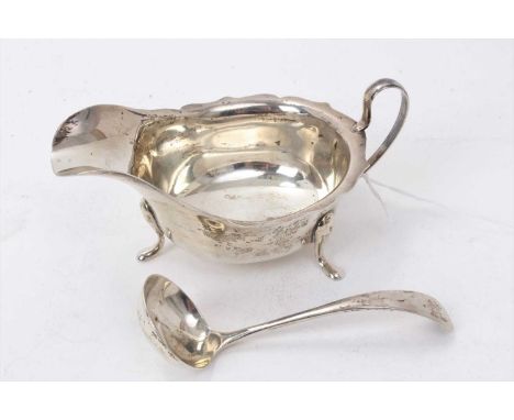 1930s silver sauce boat of conventional form with loop handle on four pad feet (Sheffield 1937) E.Viner together with a match
