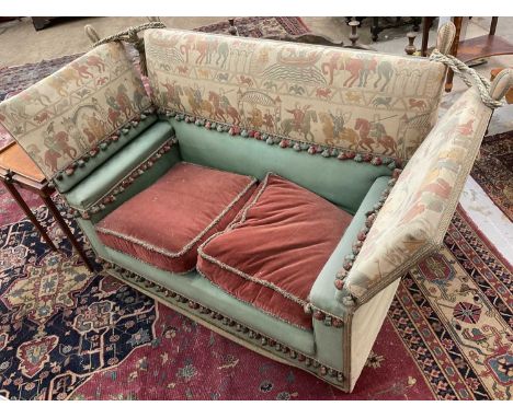 Knowle settee, with Bayeux tapestry embroidery frieze and drop ends, approximately 156cm wide. Provenance: From the Estate of