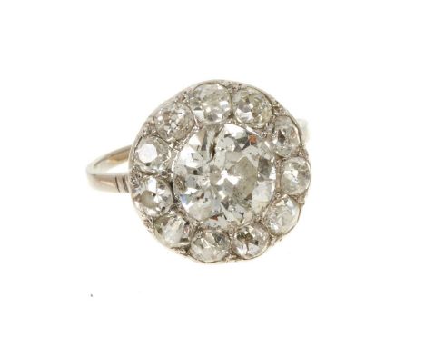 Antique diamond cluster ring with a central old cut diamond estimated to weigh approximately 1.5-1.7cts, surrounded by a bord