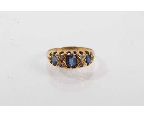 Late Victorian sapphire and diamond ring with three mixed cut blue sapphires and four rose cut diamonds in 18ct gold setting,