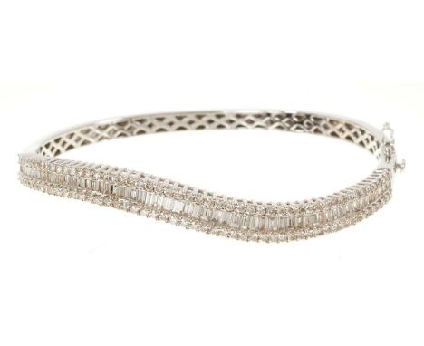 Diamond bangle with baguette cut and brilliant cut diamonds in 18ct white gold. Estimated total diamond weight approximately 