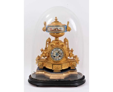 19th century French porcelain and gilt mounted mantel clock under a glass dome. The clock with Sèvres-style porcelain dial an