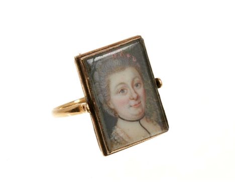 A rare George III double portrait ring with a double-sided revolving bezel containing two portrait miniatures on ivory depict