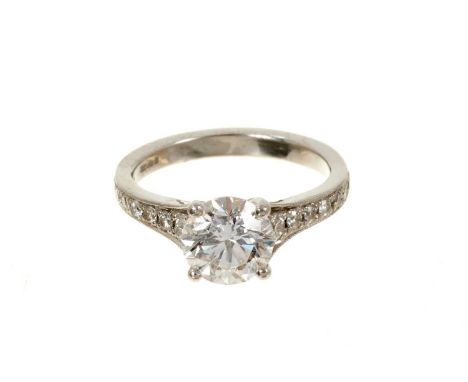 Diamond single stone ring with a round brilliant cut diamond weighing 1.51cts in platinum four claw setting with graduated di