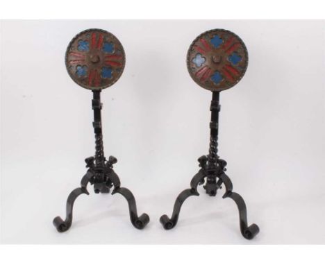 Pair of Arts &amp; Crafts wrought iron fire dogs of Gothic style, each with tracery roundel on scrolling tripod supports, 56c