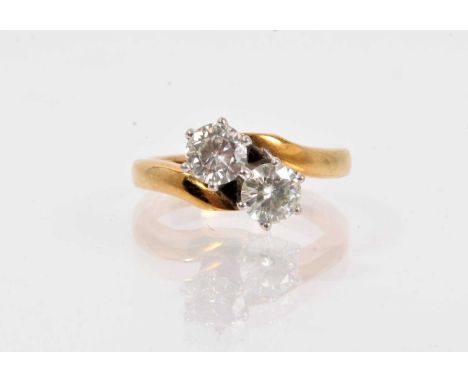 Two stone cross-over ring set with moissanite stones in 18ct gold setting, ring size J½-K.