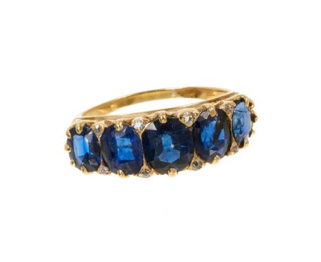 Antique sapphire five stone ring with five graduated oval mixed cut blue sapphires with rose cut diamond accents to the claws