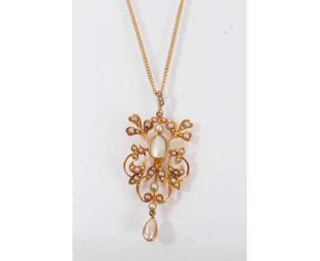 Edwardian 15ct gold and seed pearl pendant with openwork floral scrolls on a later 9ct gold chain, the pendant 50mm.Good cond
