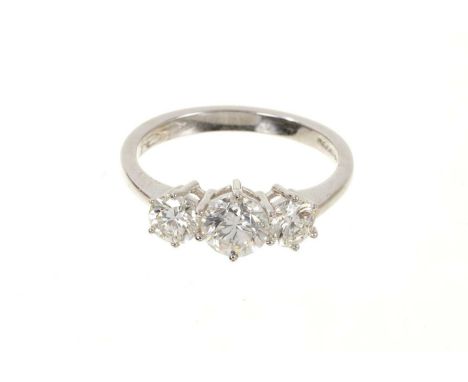 Diamond three stone ring with three round brilliant cut diamonds in claw setting on 18ct white gold shank. Estimated total di