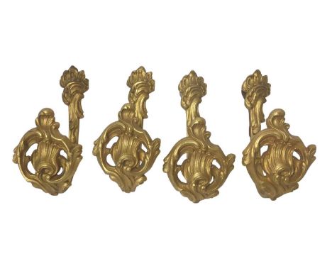Set of four 19th century gilt metal curtain tie-backs, in the rococo style, impressed marks, 20cm high. Provenance: From the 