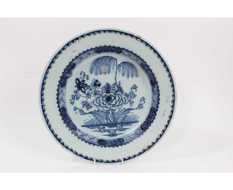 18th century blue and white Delftware dish, decorated in the Chinese style with a willow tree and peony pattern, 30.5cm diame
