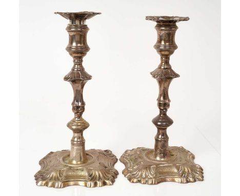 Pair George II cast silver candlesticks, with knopped columns on shaped bases, with stylised shell decoration and engraved ar