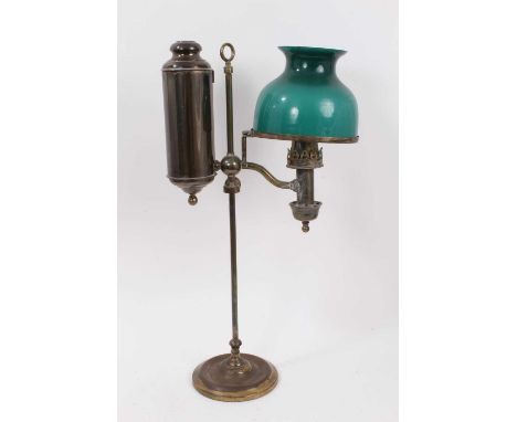 Late 19th century brass paraffin desk lamp, with green glass shade, the lamp and reservoir, adjusting on a central support, o