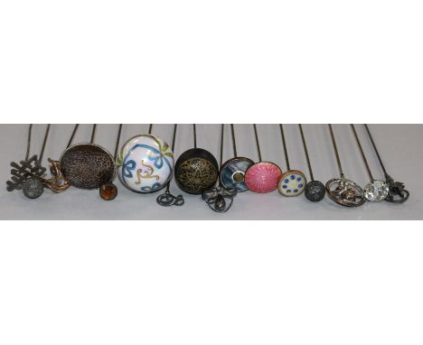 Fifteen assorted hatpins including enamel and shell.