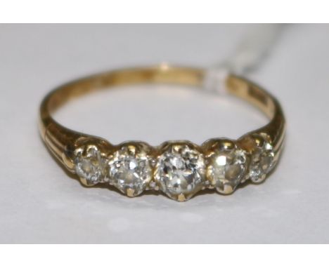 An 18ct gold and five stone diamond ring, size S.