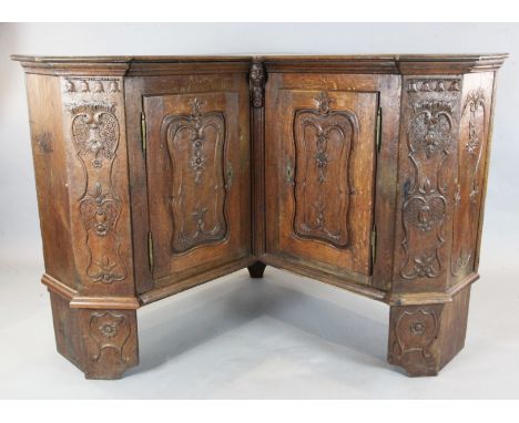 An 18th century French oak corner armoire, with two doors, on bracket feet, W.5ft 8in. D.1ft 10in. H.3ft 9in.