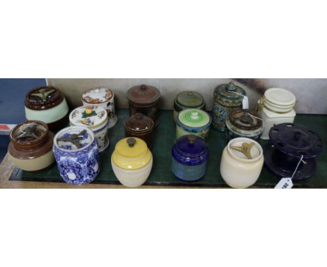 A Royal Doulton tube-lined tobacco jar, fifteen other tobacco jars, various and a pottery pipe rack (17)