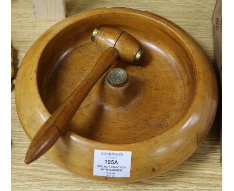 A large round wooden walnut nutcracker with hammer