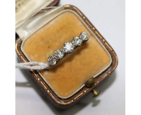 An early 20th century 18ct gold and graduated five stone ring, size O.