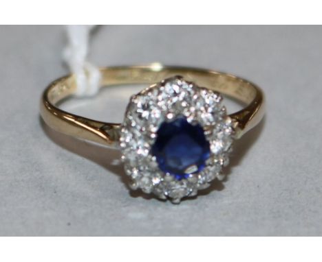 An 18ct gold and platinum, sapphire and diamond ring, size O.