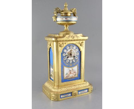 A late 19th century Louis XVI style gilt spelter eight day striking mantel clock, with Sevres style inset panels, 19.75in.
