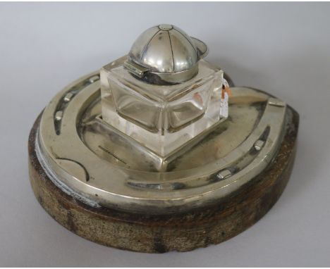 An Edwardian electroplate horseshoe and jockey's cap inkwell by Daniel & Arter