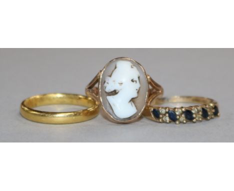 A 22ct gold wedding band, a 9ct gold cameo ring and a 9ct gold gem set ring.