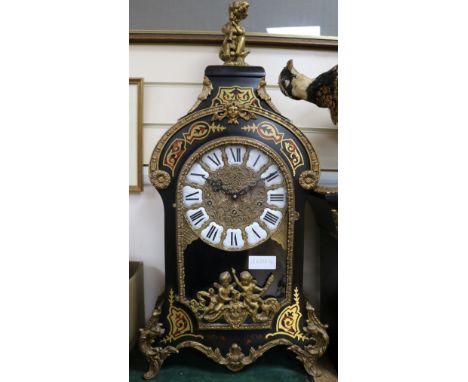 A Louis XV style ebonised eight day chiming mantel clock on matching stone, Clock H.75cm, Stand H.115cm