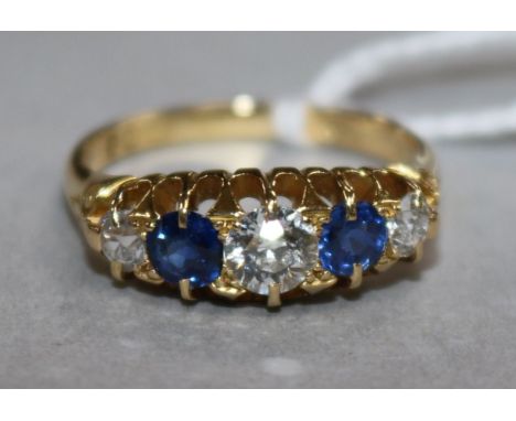 An early 20th century 18ct gold and graduated five stone sapphire and diamond ring, size R.