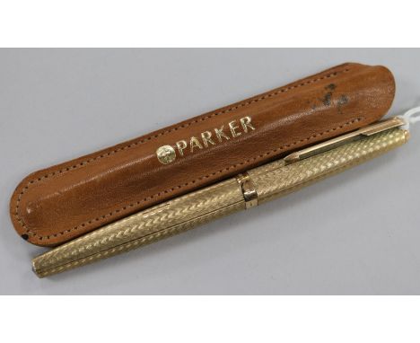 An engine turned 9ct gold Parker fountain pen.