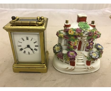 A Rockingham pastille burner in the form of a cottage, c1825; together with a French miniature carriage clock