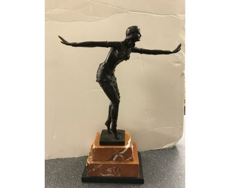 A bronze figure of a dancing lady on a marble base