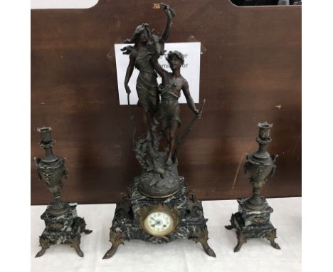 A 19th century French marble and spelter clock garniture with "La Chase" by Bouchon.  Garniture of urns on matching marble, 5