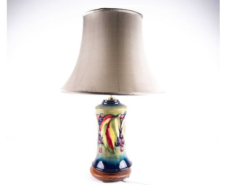 A Moorcroft 'Leaf & Berry' pattern table lamp, third quarter 20th century, the stepped top above a waisted cylindrical body w