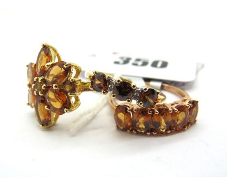 The Genuine Gemstone Company; A Large 9ct Gold Cluster Dress Ring, of flower head design, claw set throughout, between plain 