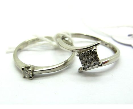 A Modern Cluster Dress Ring, inset highlights, between crossover shoulders, stamped "375 0.10", together with a claw set sing