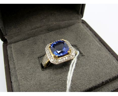 A Large 18ct Gold Tanzanite and diamond Set Square Cluster Dress Ring, cushion four double claw set to the centre, within bor