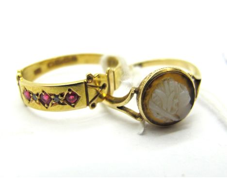 An 18ct Gold Victorian Style Dress Ring, with alternate inset highlights, within plain panel, to textured shoulders, a cameo 