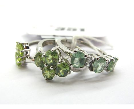 The Genuine Gemstone Company; A 9ct White Gold Cluster Dress Ring, claw set highlights, within  textured shoulders; a 9ct whi