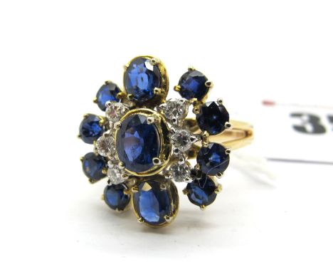 A Modern Stone Set Cluster Dress Ring, claw set throughout, within bifurcated shoulders.