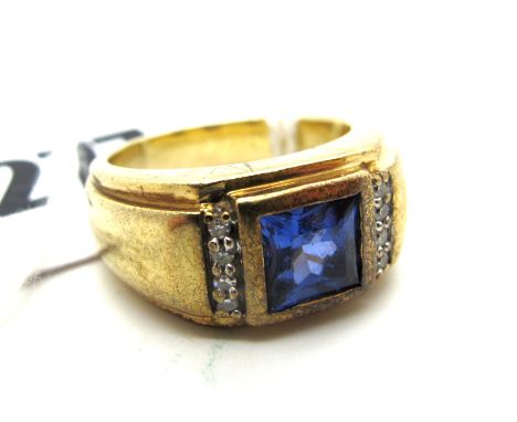 An Ornate Sapphire and Diamond Dress Ring, the collet set centre within claw set highlights and wide tapering shoulders, stam