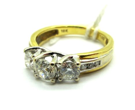 A Modern 18ct Gold Three Stone Diamond Ring, graduated claw set, between diamond set channel shoulders, stamped "1.00" "18K".