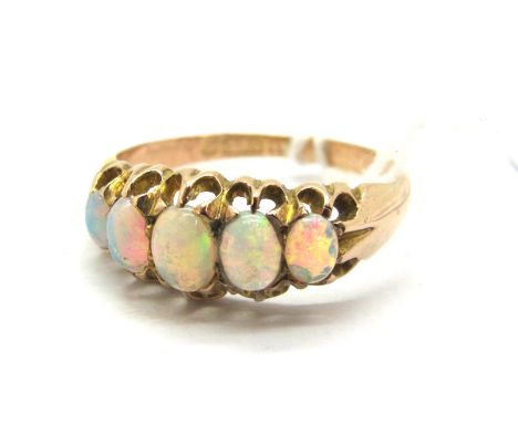 A Victorian Style Dress Ring, with graduated claw set cabochon highlights, within openwork setting and textured shoulders, st