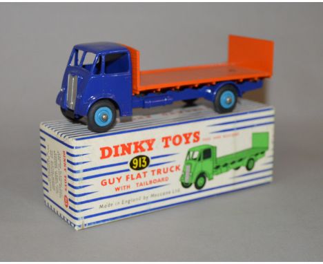 Dinky Toys #913 Guy Flat Truck with Tailboard, in mid-blue with orange back and light blue hubs.