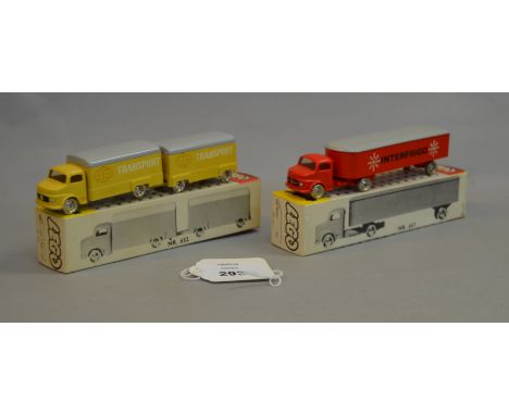 Two Lego plastic vehicles: #652 Covered Truck 'Transport' in yellow; #657 Long Covered Van 'Interfrigo' in red. Both boxed. (