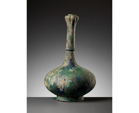 A GARLIC HEAD BRONZE BOTTLE VASE, HAN DYNASTYChina, 202 BC to 220 AD. The finely cast vessel of compressed globular form with