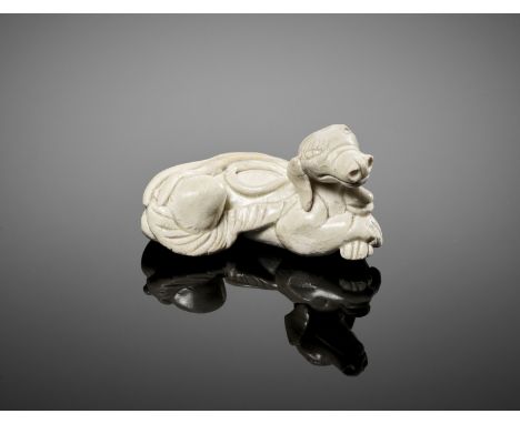 A QINGBAI CERAMIC FIGURE OF A DOG, SONG DYNASTYChina, 12th - 13th century. The dog freely modeled in a reclining pose, the fr