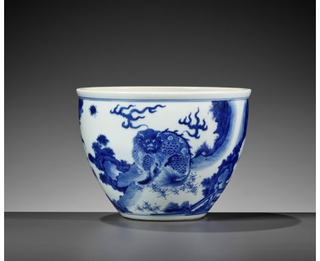 A BLUE AND WHITE 'MYTHICAL BEASTS' JARDINIERE, QING DYNASTYChina, 19th century. The deep rounded sides rising from a short ta